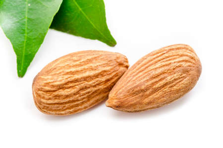 Almonds with leaves isolated on white backgroundの写真素材