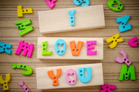 Colorful alphabet of LOVE wording on wooden background.の写真素材