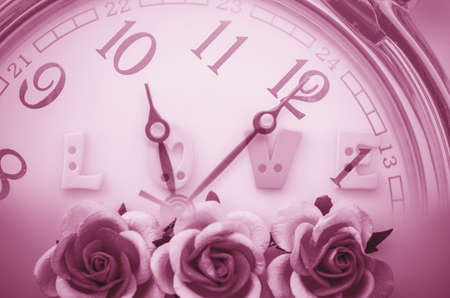 Vintage pink roses flower and love face time background. Time and love concept.の写真素材