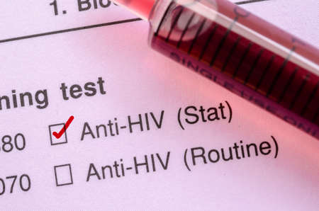 Red correct check mark with blood sample in syringe for HIV test form request.の写真素材