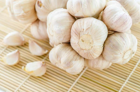 Organic garlic whole on the wooden mat background