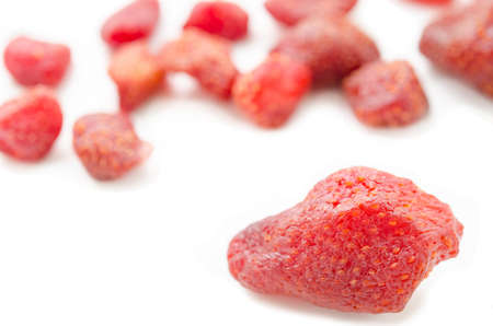 Pile of tasty red dried dehydrated strawberries on white background.の写真素材