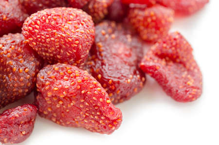 Pile of tasty red dried dehydrated strawberries on white background.の写真素材