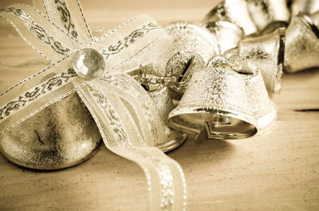 Christmas decoration. Silver bell in vintage background.の写真素材