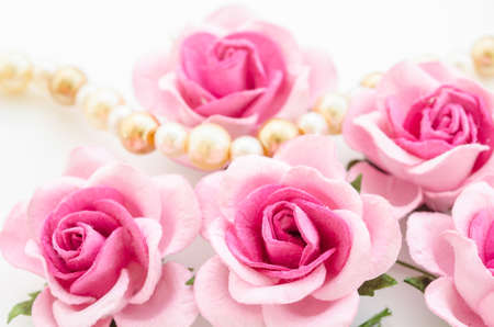 Pink rose with pearls on white background.の写真素材