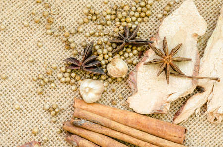Collection of spices for mulled wine and pastry on sack background.の写真素材