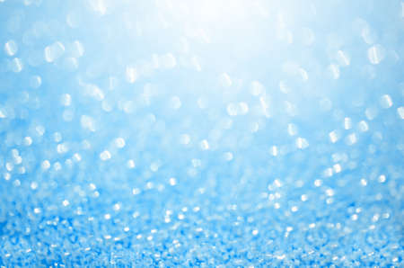 Abstract blue glitter background. Shiny glitter bokeh christmas background.の写真素材