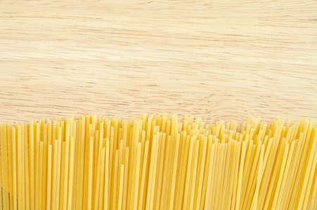 Raw spaghetti on wooden background.の写真素材