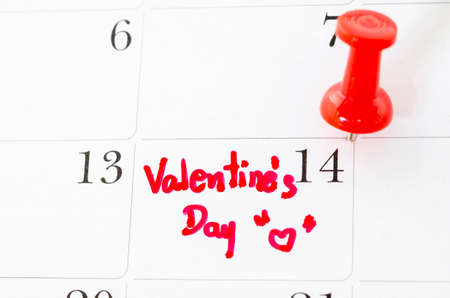 Calendar page with the red hearts on February 14 of Saint Valentines day.の写真素材