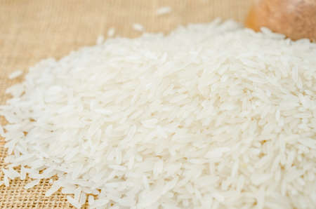 Raw Jasmine rice on sack background.の写真素材