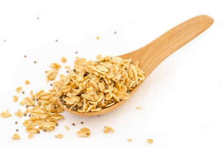 Granola in wooden spoon on white background.の写真素材
