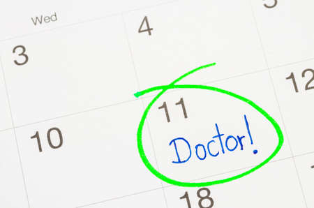 The words Doctor written on a Calendar to Remind you an Important Appointmentの写真素材