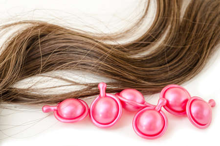 Hair serum and damaged hair on white background.の写真素材