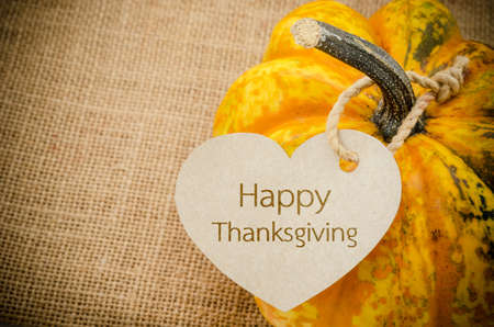 Happy Thanksgiving paper price tag with pumpkin - holiday shopping concept.の写真素材