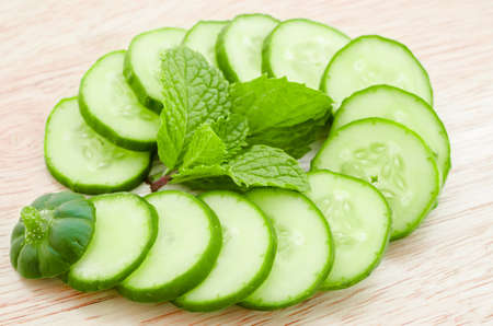 cucumber slices with mint leaf on wooden backgroundの写真素材