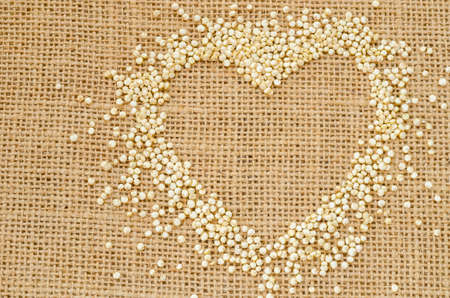 Heart of quinoa grain on sack background.の写真素材