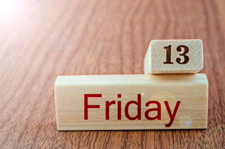 Friday the thirteenth on wood backgroundの写真素材