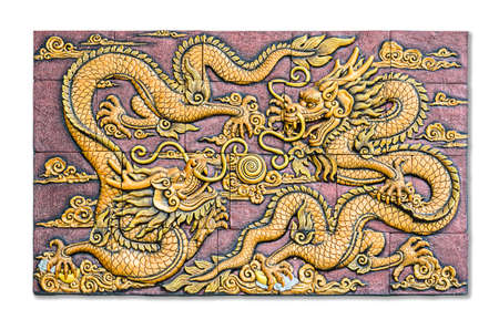 Two Chinese style golden dragons fighting as low relief technique mass product artwork isolated on white background, clipping path.の写真素材