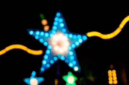 Abstract star shape bokeh light night background of town.の写真素材