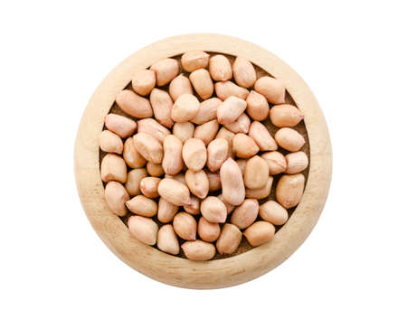 Dry peanut seeds in wooden dish isolated on white background