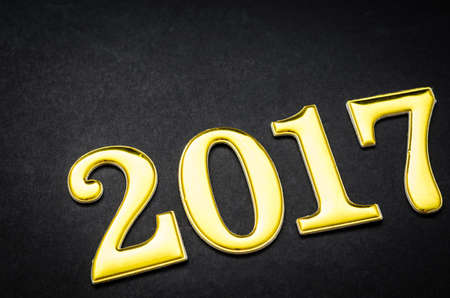 Sigh symbol from 2017 gold numbers on black background.の写真素材