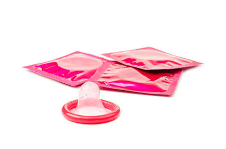 Pink condom on white backgroundの写真素材