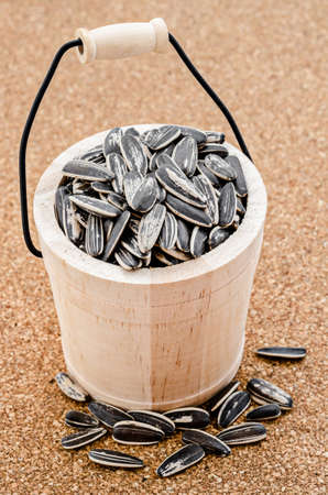 Sunflower seeds in a wooden casks on table.の写真素材