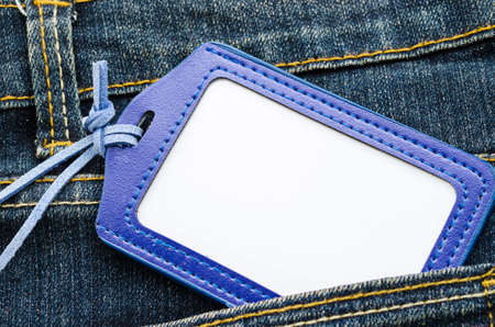 Blank leather name tag on blue jean, ready for text or message.の写真素材