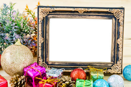 Vintage blank photo frame with christmas decoration on wooden background.の写真素材