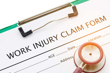 Claim form for an injury at work with stethoscope.の写真素材