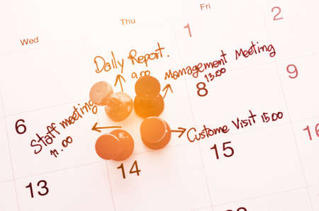 Pushpin on calendar with busy day overworked schedule with filter.の写真素材
