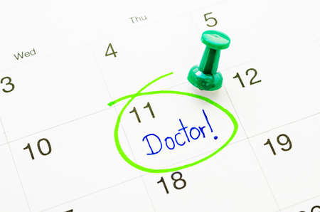 The words Doctor written on a Calendar to Remind you an Important Appointmentの写真素材