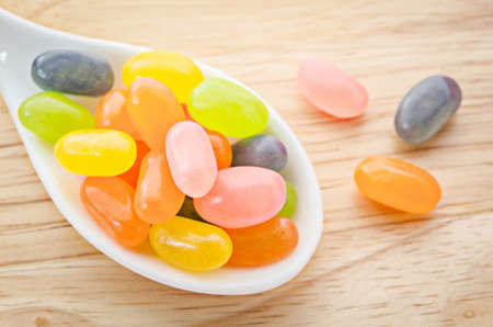 Sweet Sugar Candy in white spoon on sack background.