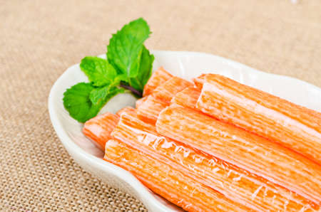 Crab sticks in white dish on sack background.の写真素材