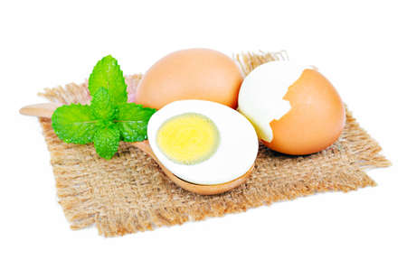boiled egg in wooden spoon on white background
