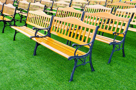 Wooden bench vintage on green grass at public park.の写真素材