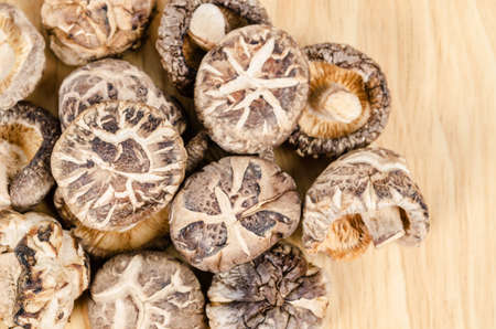 dried shiitake mushrooms on wooden background.