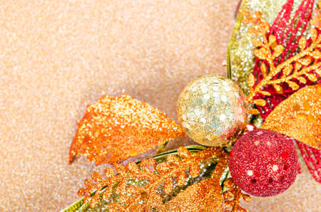 Gold Christmas ball with bow on golden background for christmas.の写真素材