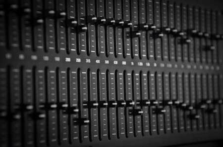 Part of an audio sound mixer with buttons and sliders