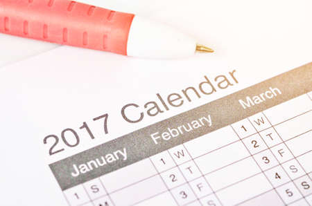 Close up calendar 2017 with pen on white background.