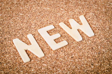 NEW word alphabet wood on wooden background.の写真素材