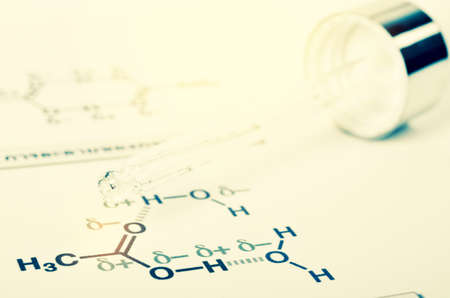 Laboratory glass Pipette on Chemical formula paper with light tone select focusの写真素材