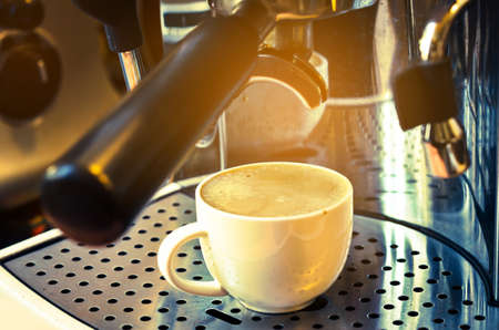 Professional coffee machine making espresso in a cafe with lighting.の写真素材