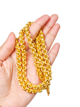 Golden necklace in left hand isolated on white background, Saved clipping path.の写真素材