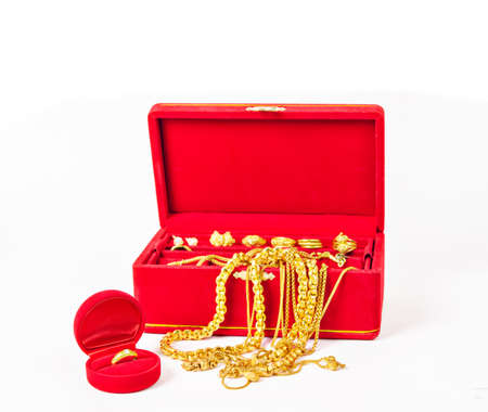 Group of gold necklace and gold accessories in red box isolated on white background.の写真素材