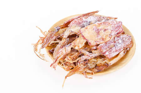 Dried squids in wooden dish isolated on white background.の写真素材