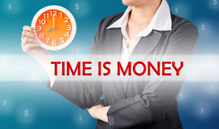 Time is money, and business woman holding clock. Business concept.の写真素材