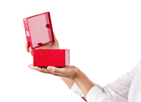 Hands holding an opened red gift box isolated on white background, Saved clipping path.の写真素材