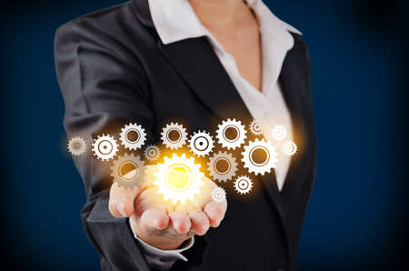 Hand of business woman showing glass gear, business success concept.の写真素材