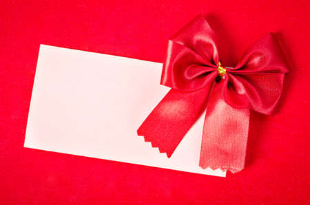Blank card with red ribbon on red background, Ready for your text or message.の写真素材